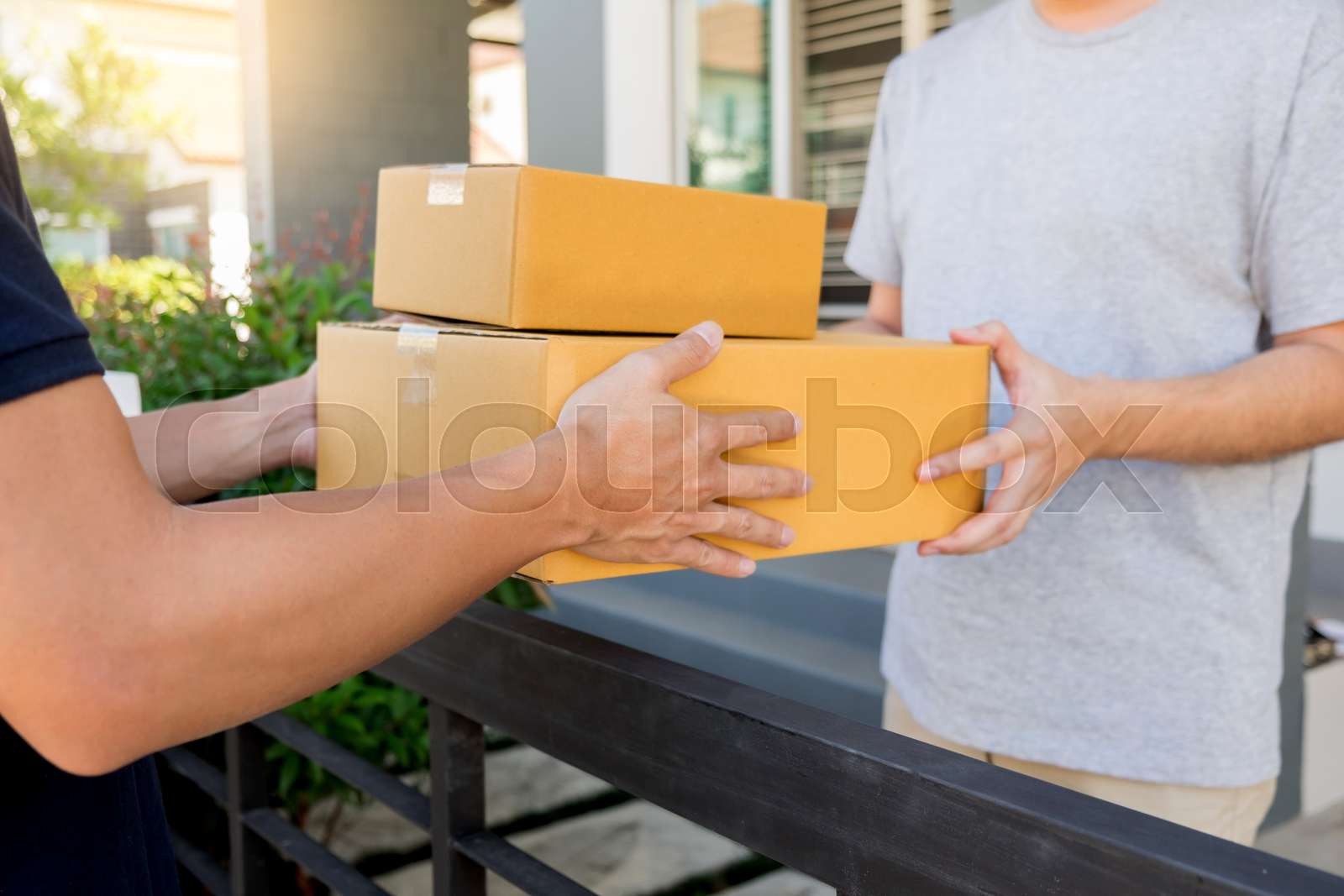delivery service concept, customer hand receiving a cardboard boxes