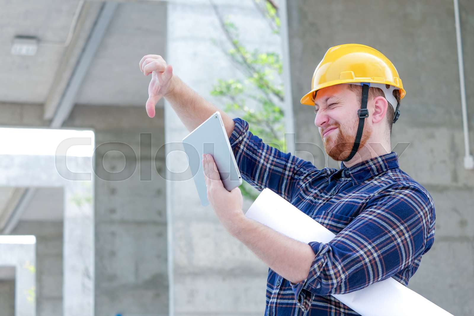 civil engineer working on building site with computer | Stock image