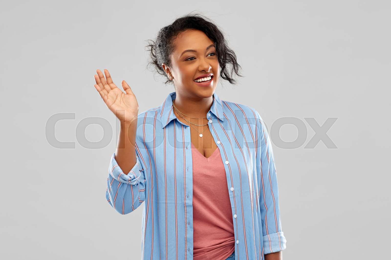 happy african american woman waving hand | Stock image | Colourbox