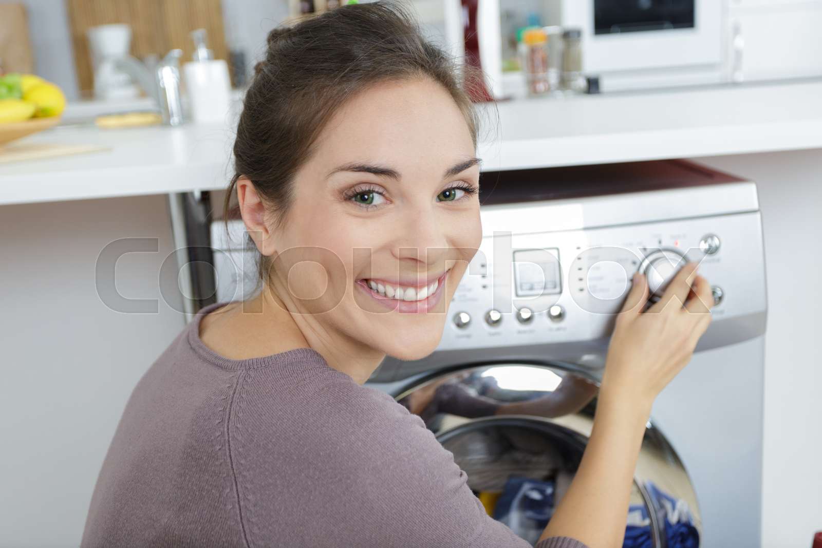 Woman Loading Dirty Clothes In Washing Machine Stock Image Colourbox