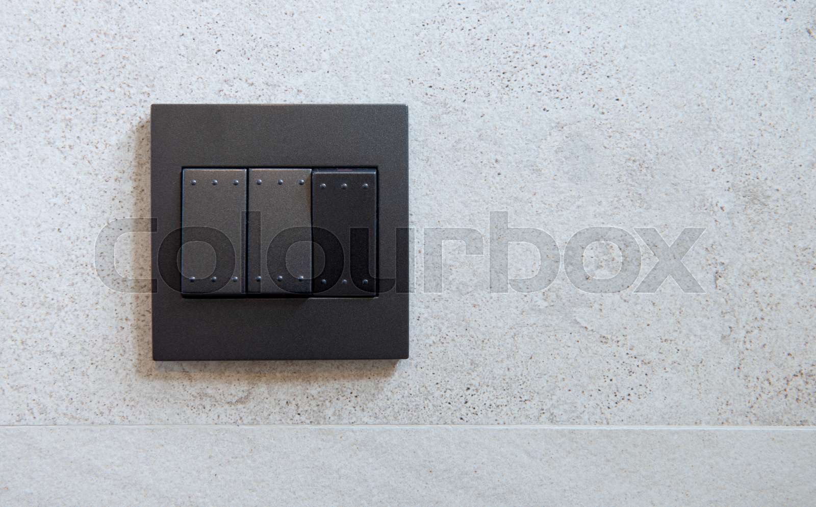 Black light switch on the wall Stock image Colourbox
