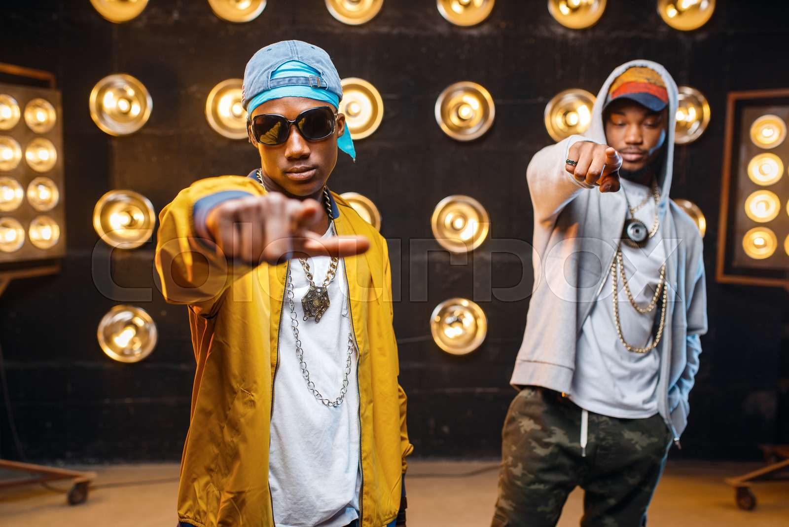 Two black rappers in caps, artists poses on stage | Stock image | Colourbox