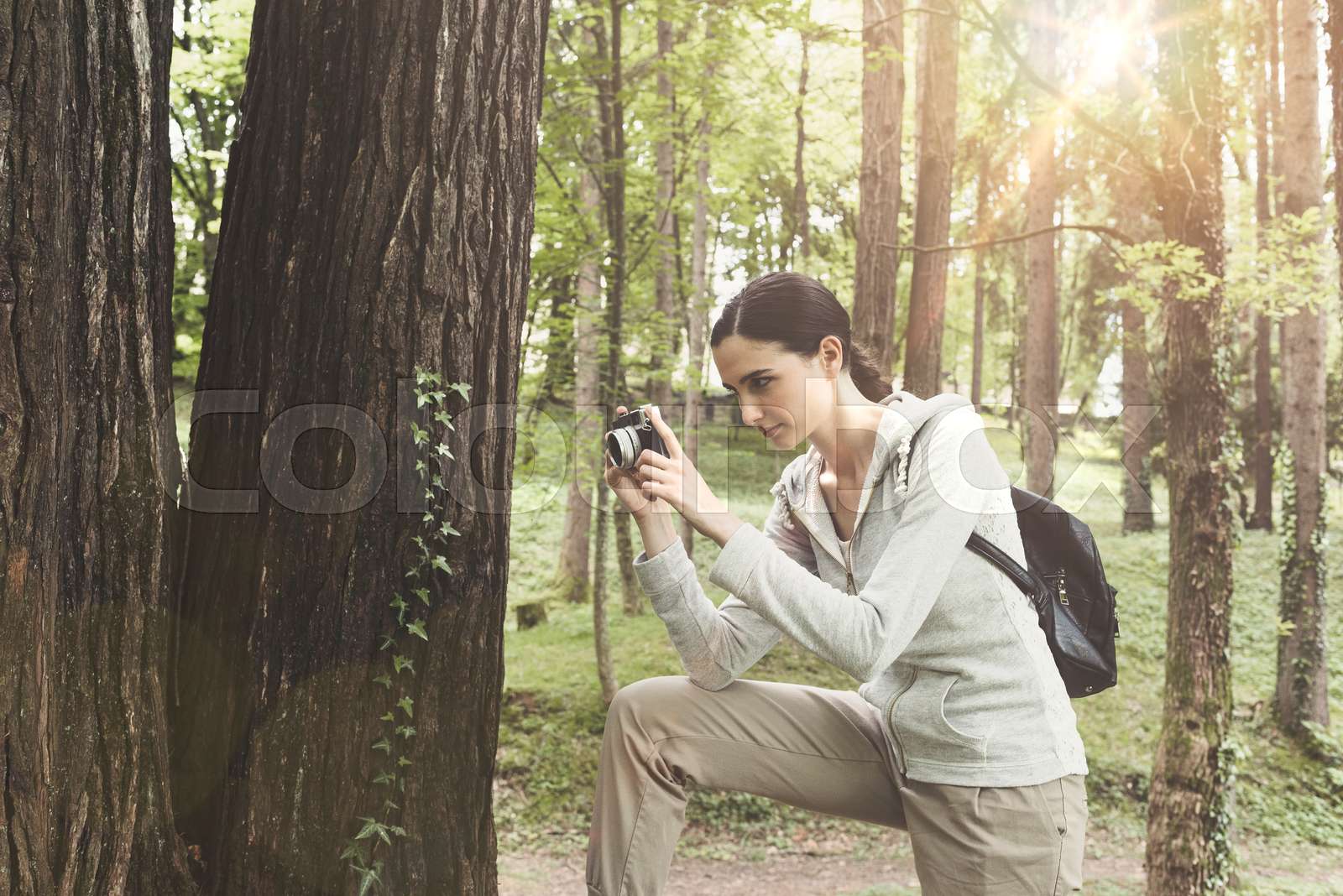 Young woman walking in nature and taking pictures | Stock image | Colourbox