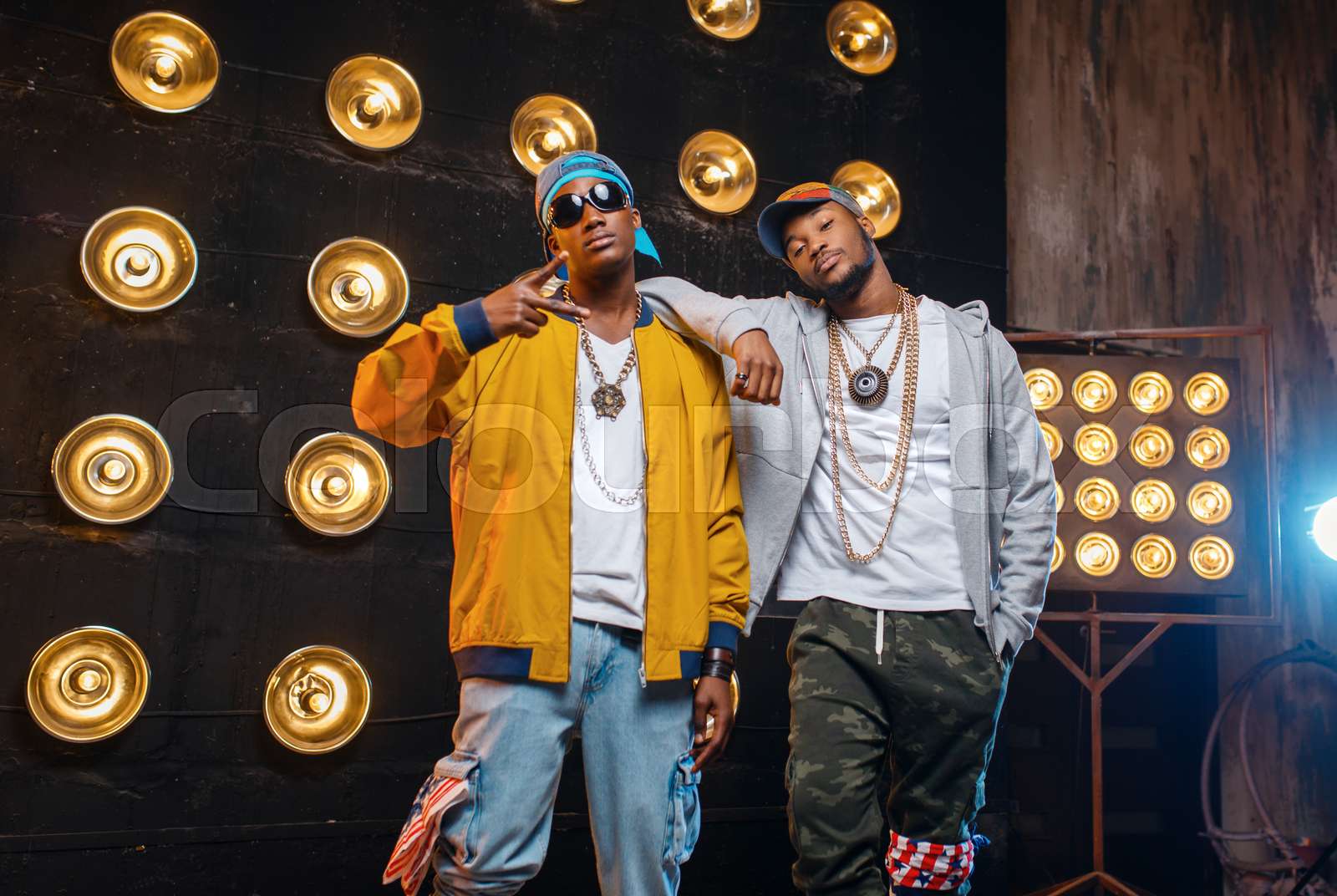 Two black rappers in caps, artists poses on stage | Stock image | Colourbox