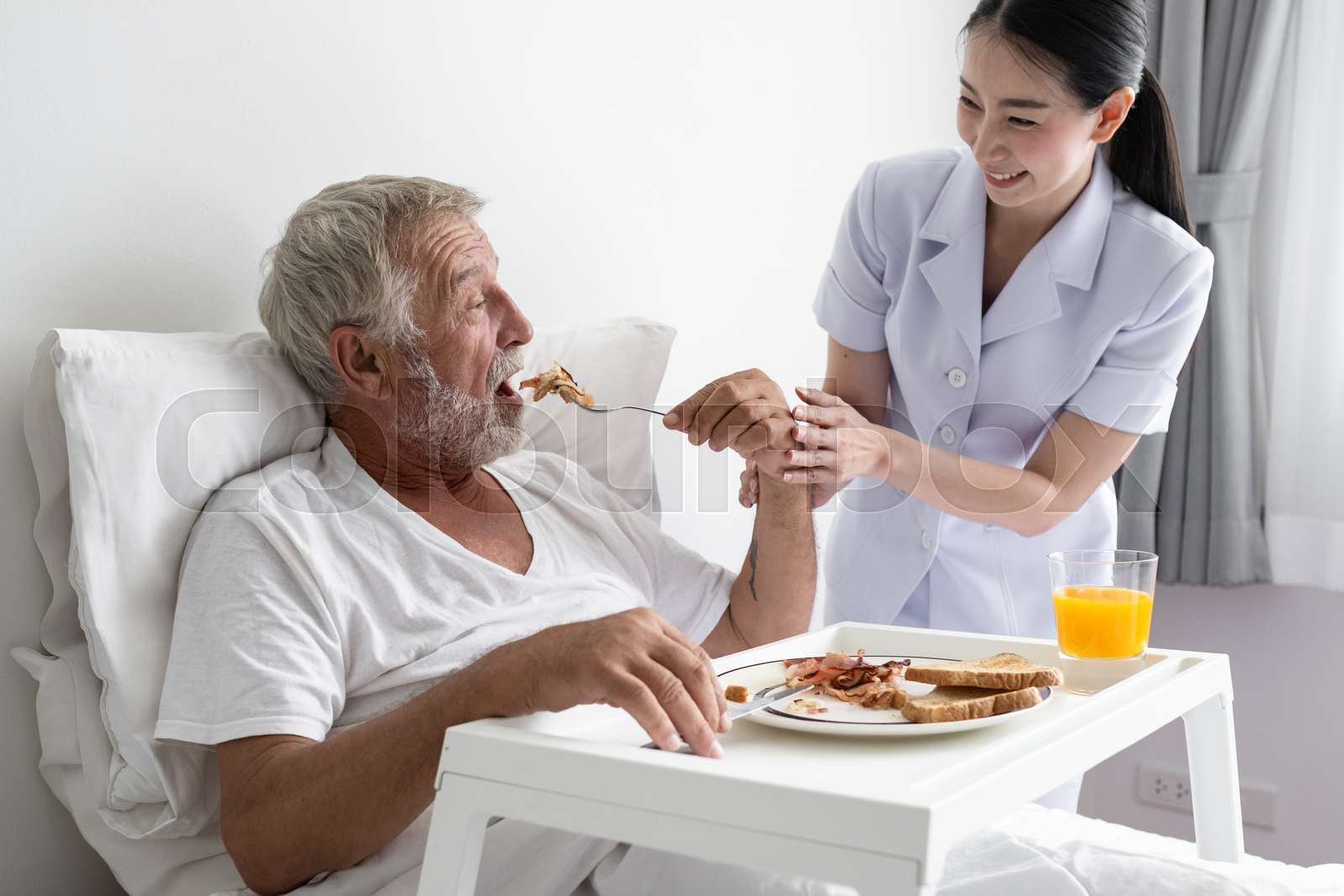 Senior Man With Smiling Nurse Takes Care Breakfast And Discussion And 