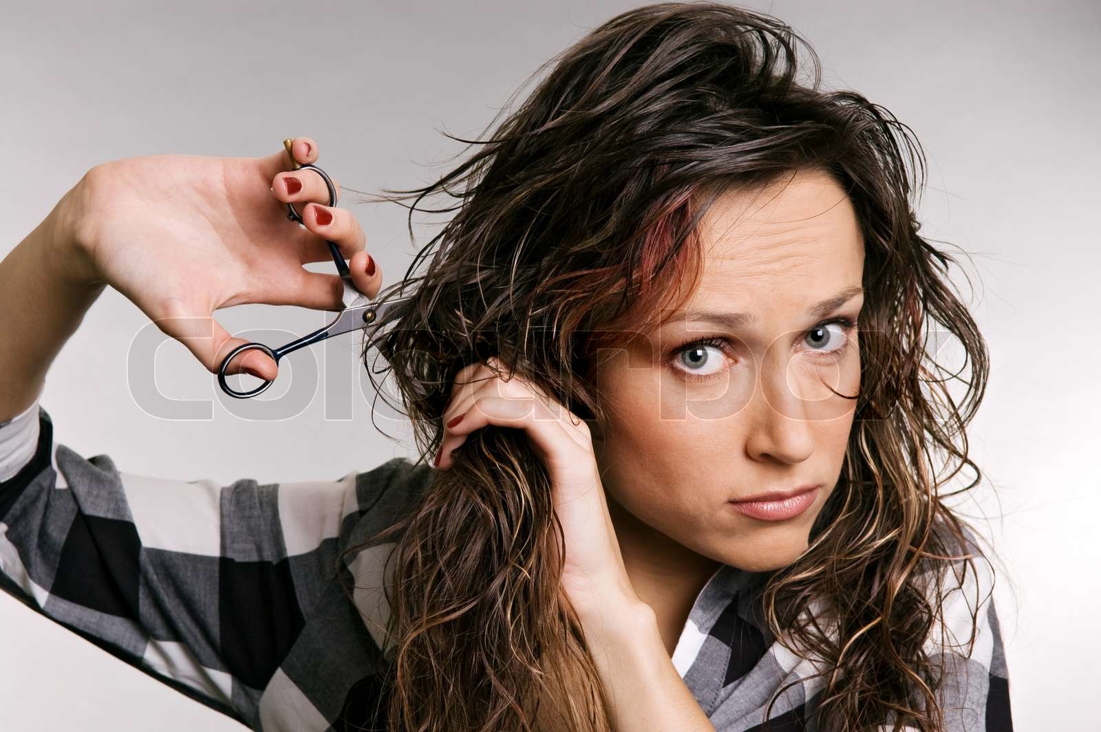 beautiful woman cutting her hair | Stock image | Colourbox