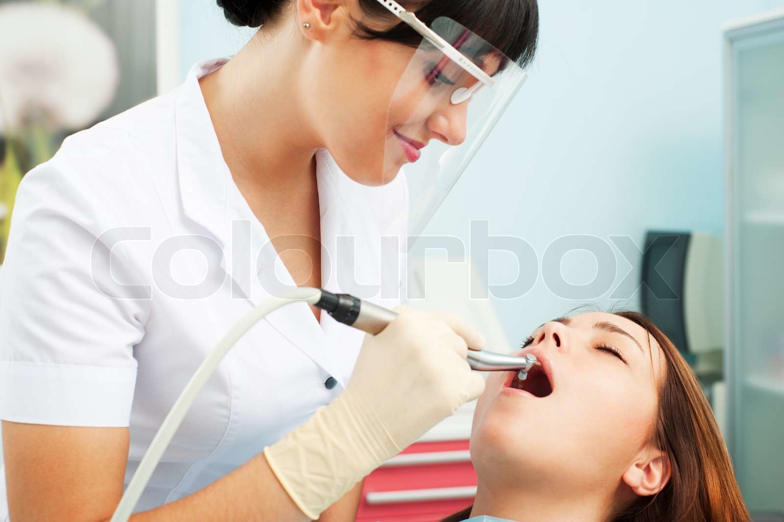 portrait of smiley dentist in mask and patient Stock image Colourbox