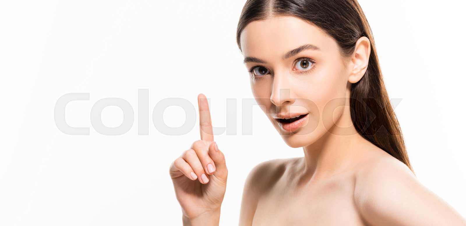 beautiful young naked woman with perfect skin looking at camera while showing idea gesture