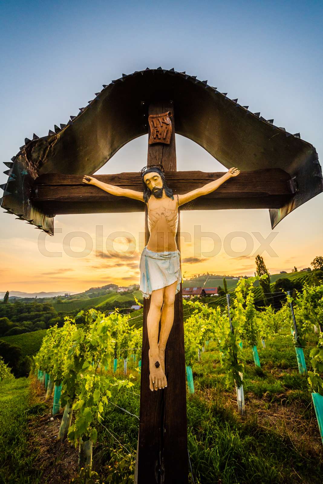 Christian wooden cross with figure of Jesus Christ at Vineyards in