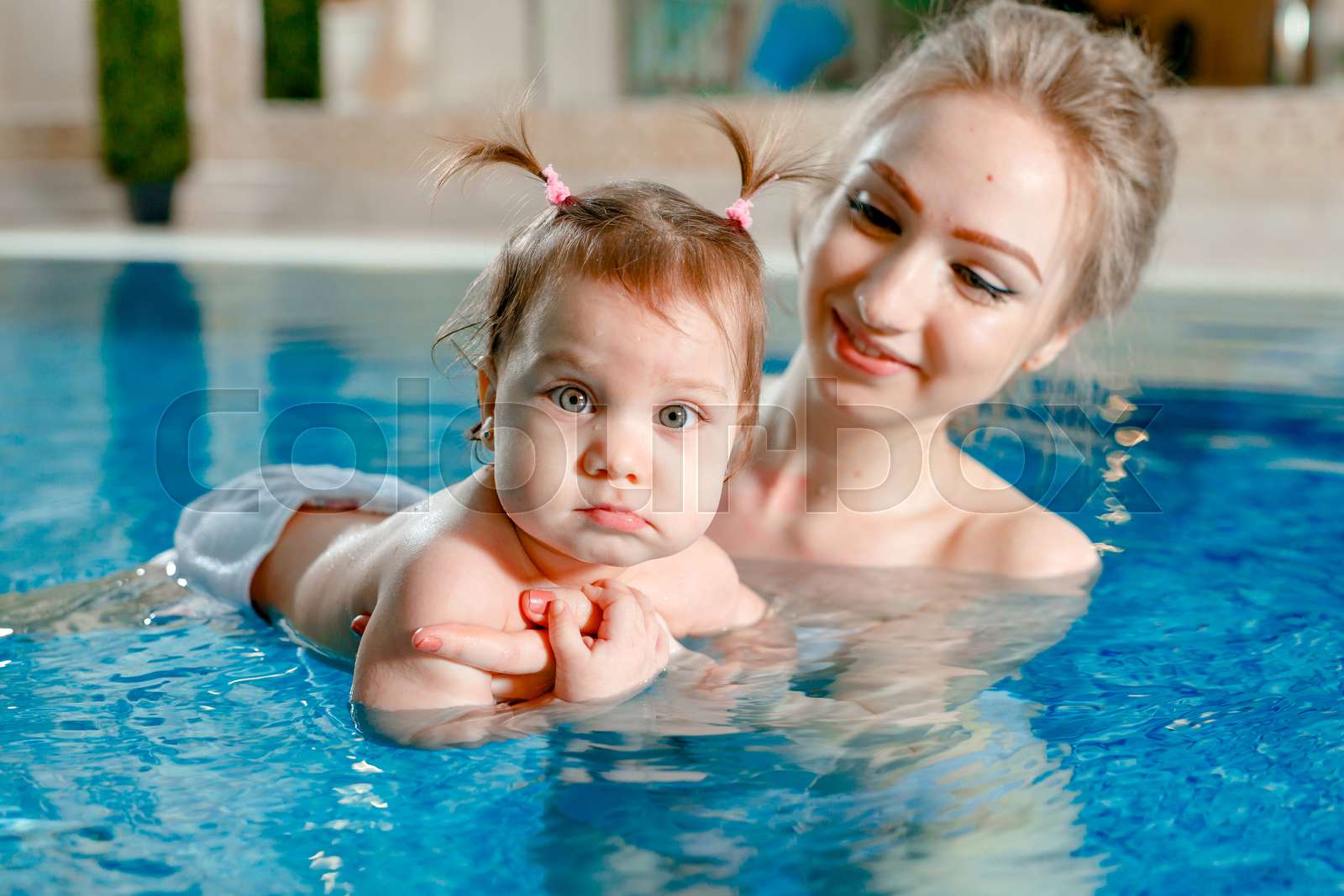 Mom and baby swim in the pool. | Stock image | Colourbox