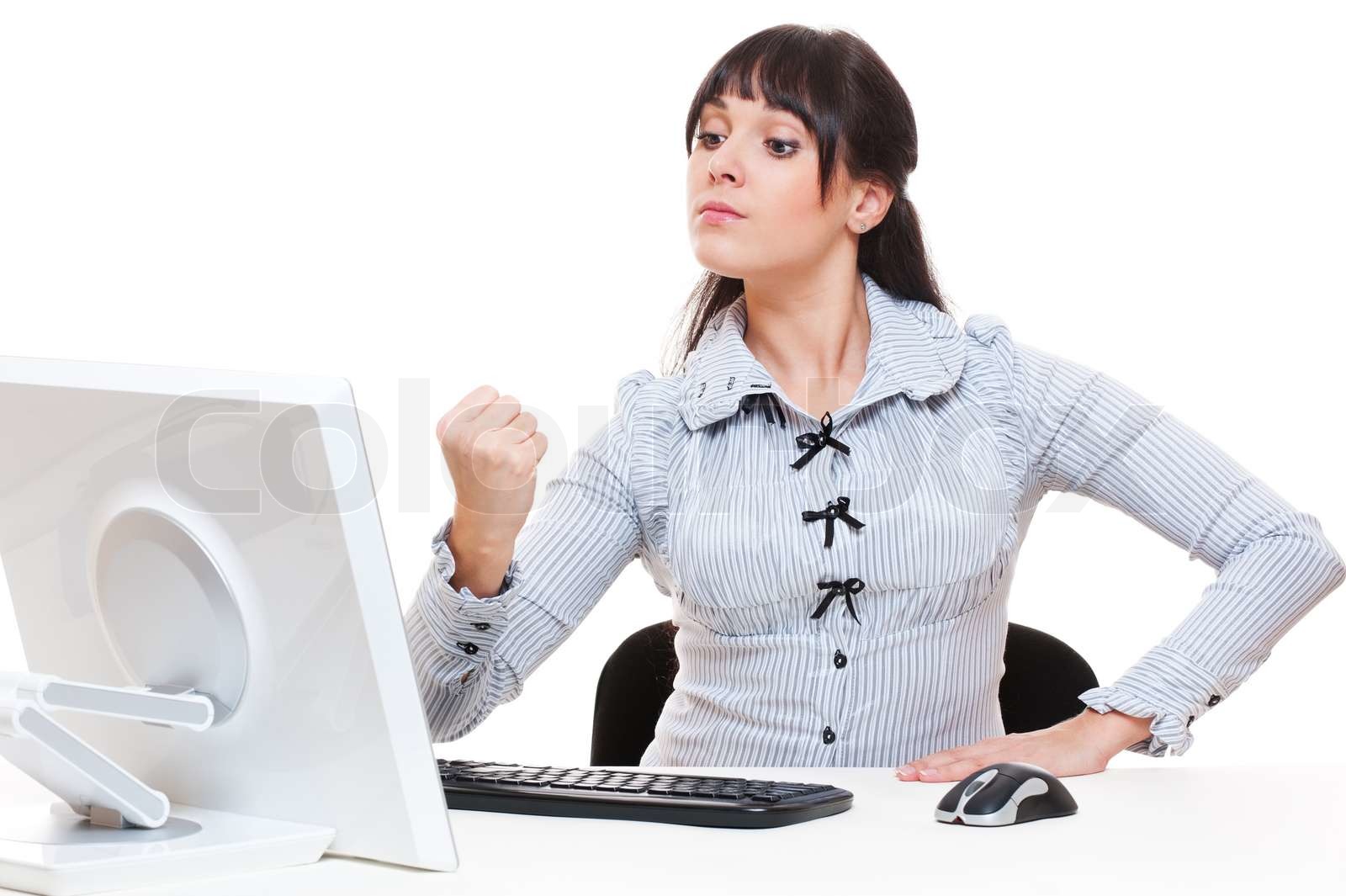 studio shot of angry woman and computer | Stock image | Colourbox