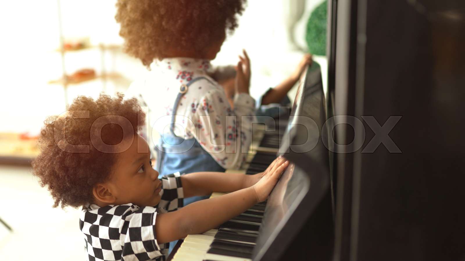 African kids are playing on piano music | Stock image | Colourbox