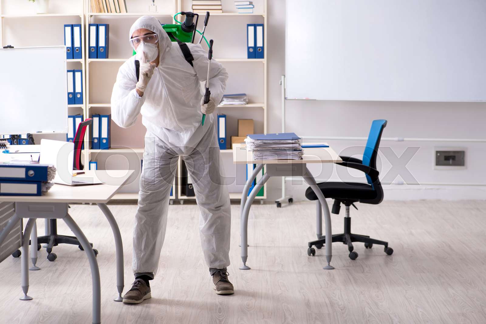 Professional contractor doing pest control at office Stock image