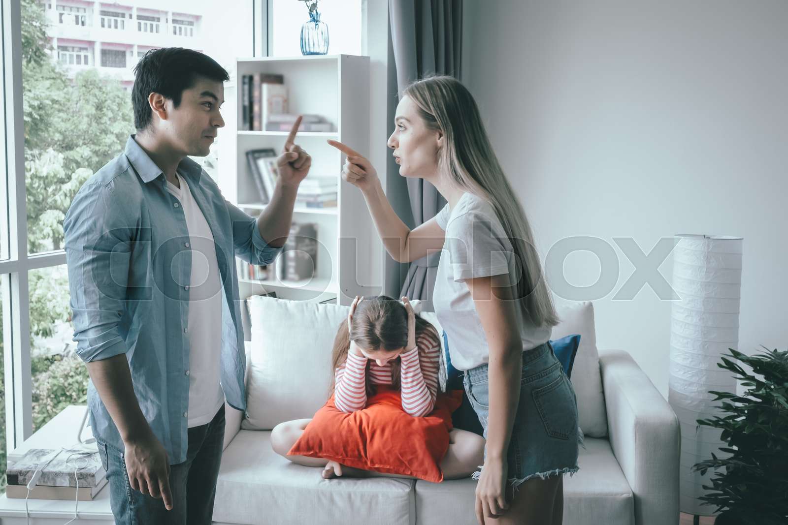 mother and father fighting together and daughter sitting with sad ...