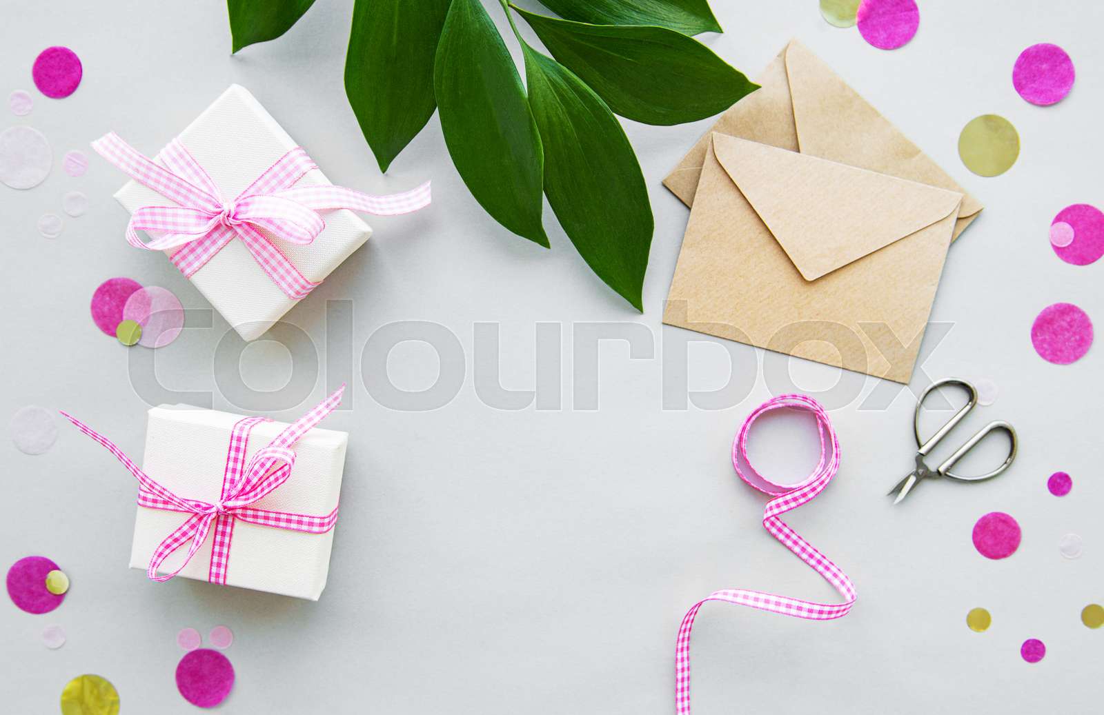 Gift boxes, envelope and with green leaves Stock image Colourbox