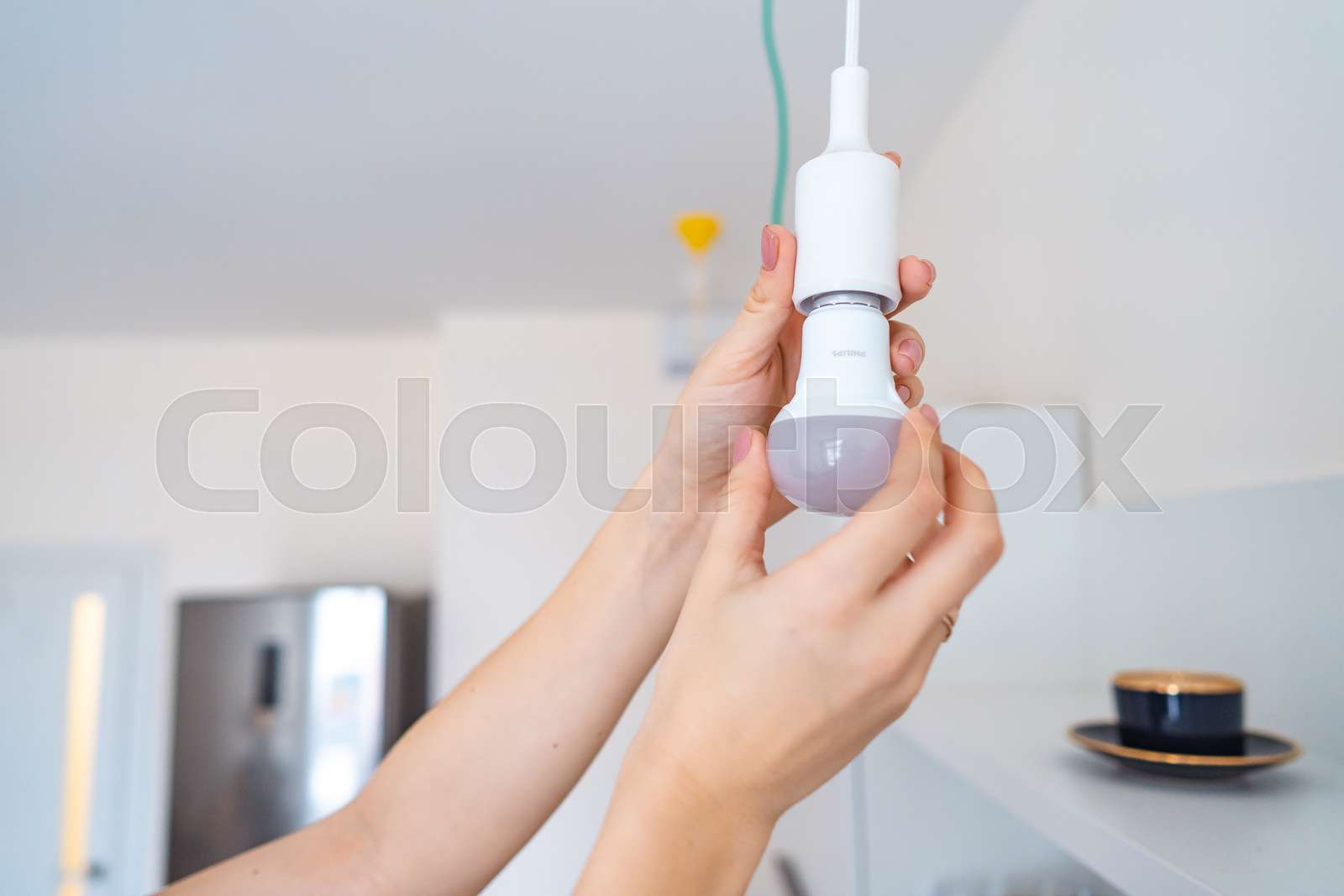 Woman unscrew a light bulb to light does not light Stock image