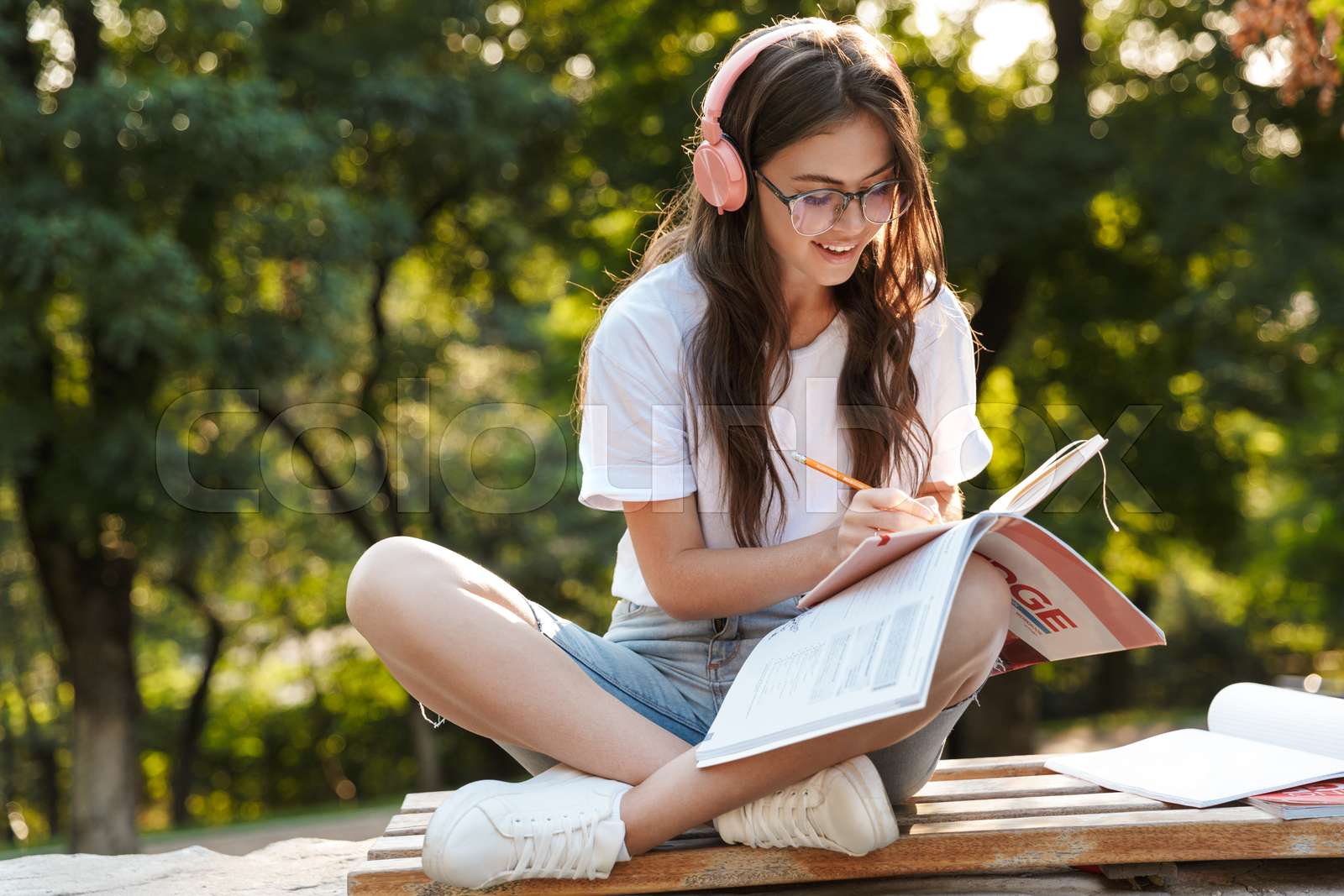 Lady outdoors in nature green park writing notes in notebook. | Stock ...
