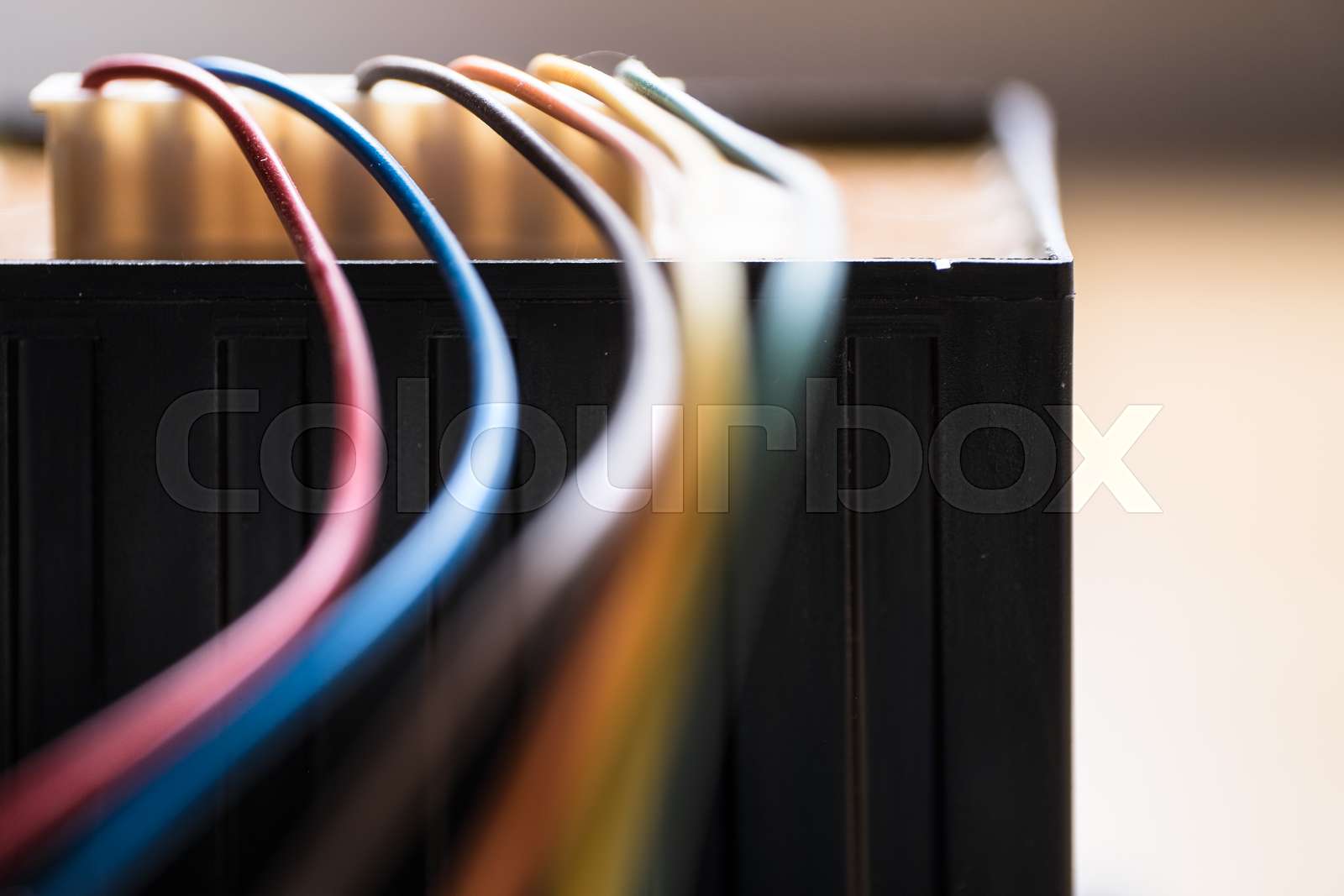 Colored power cables that come from a transformer Stock image Colourbox
