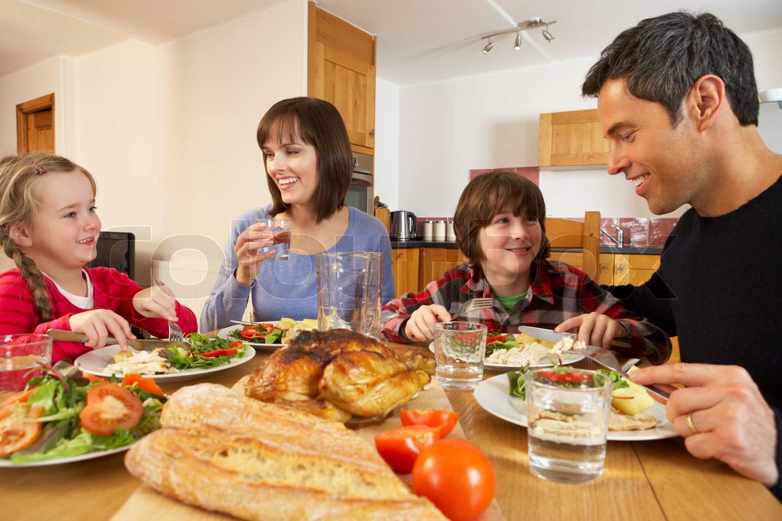 Family Eating Lunch Together In Kitchen | Stock image | Colourbox