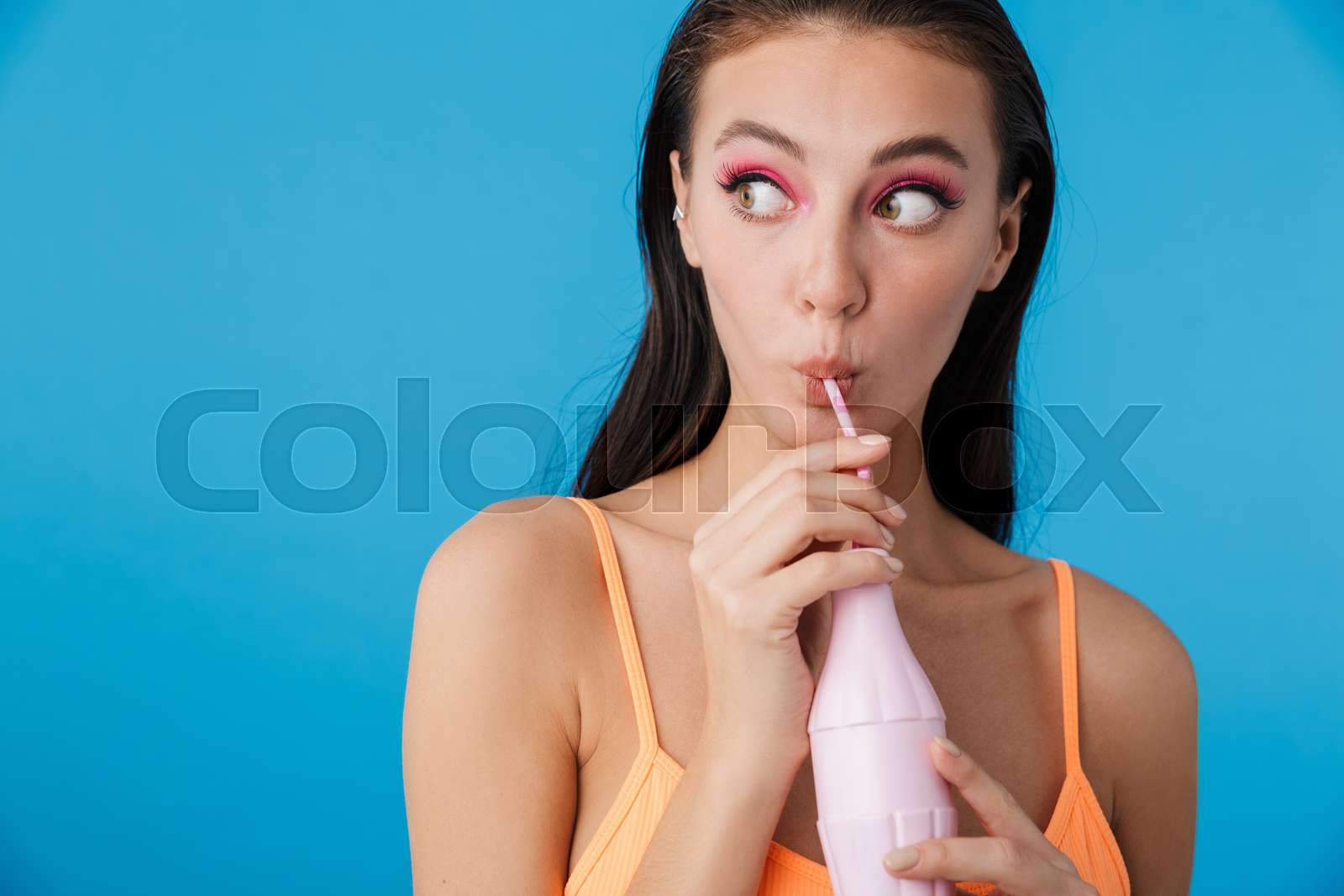 Photo Of Alluring Shocked Woman Drinking Soda From Plastic Bottle