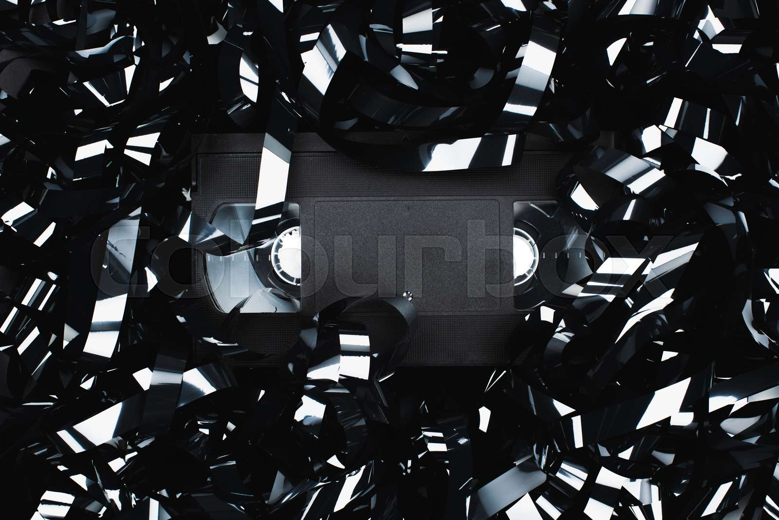 top view of black VHS cassette in film strip | Stock image | Colourbox