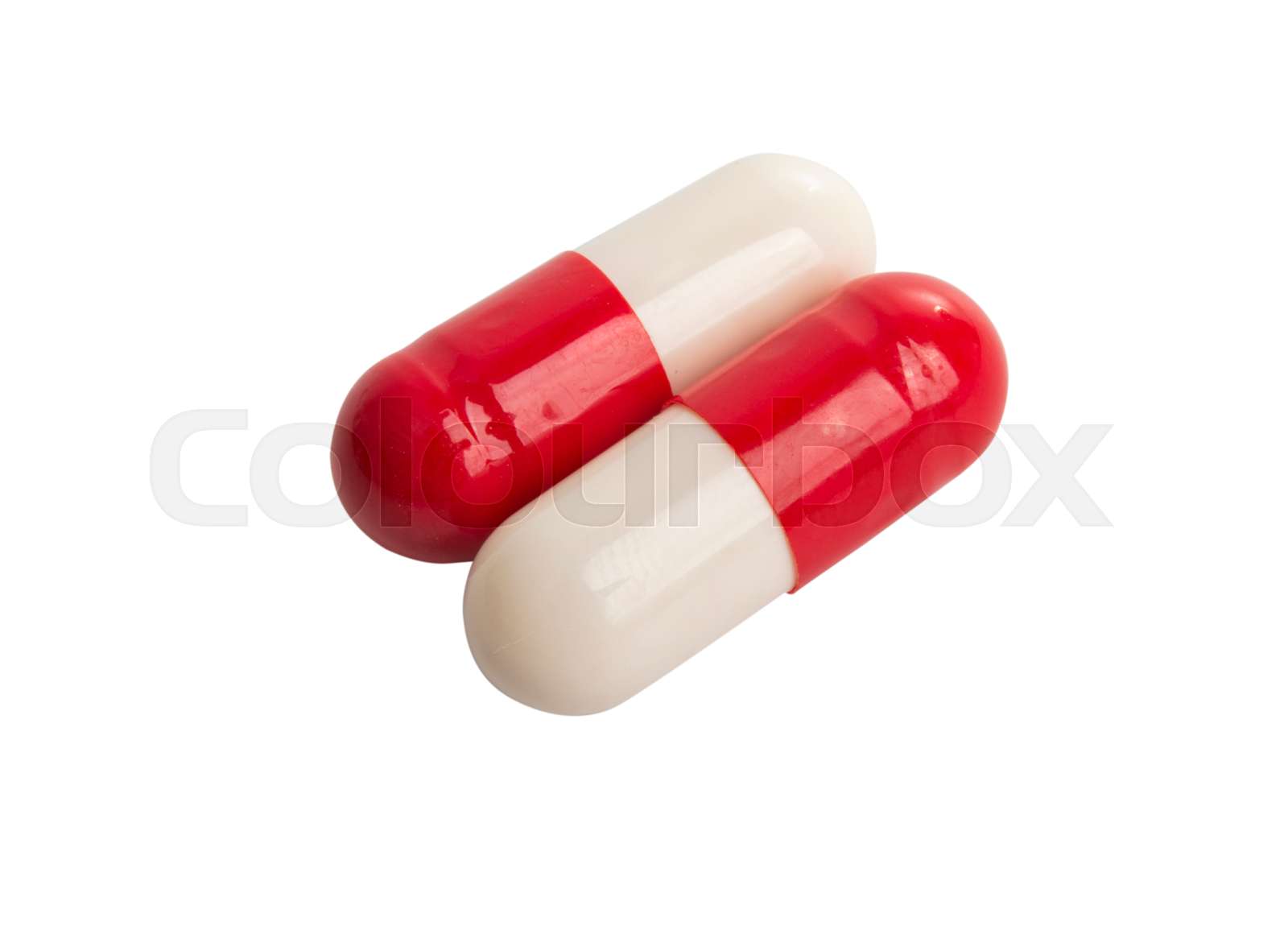 redwhite capsules isolated Stock image Colourbox