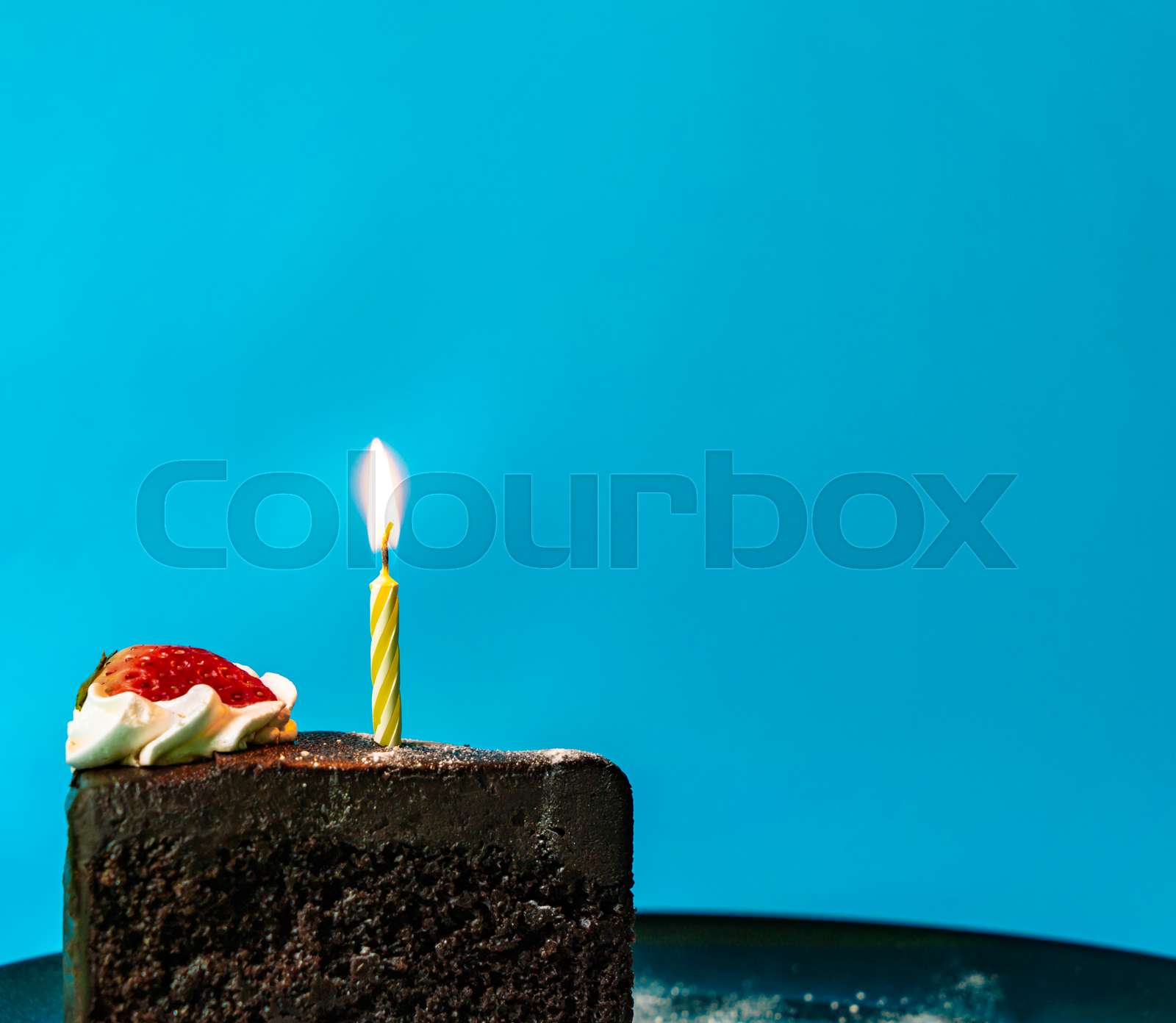Candle with fire on cake for birthday | Stock image | Colourbox