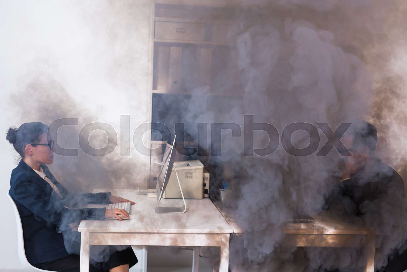 Close-up of fire burning inside the office cabin during works. Men and