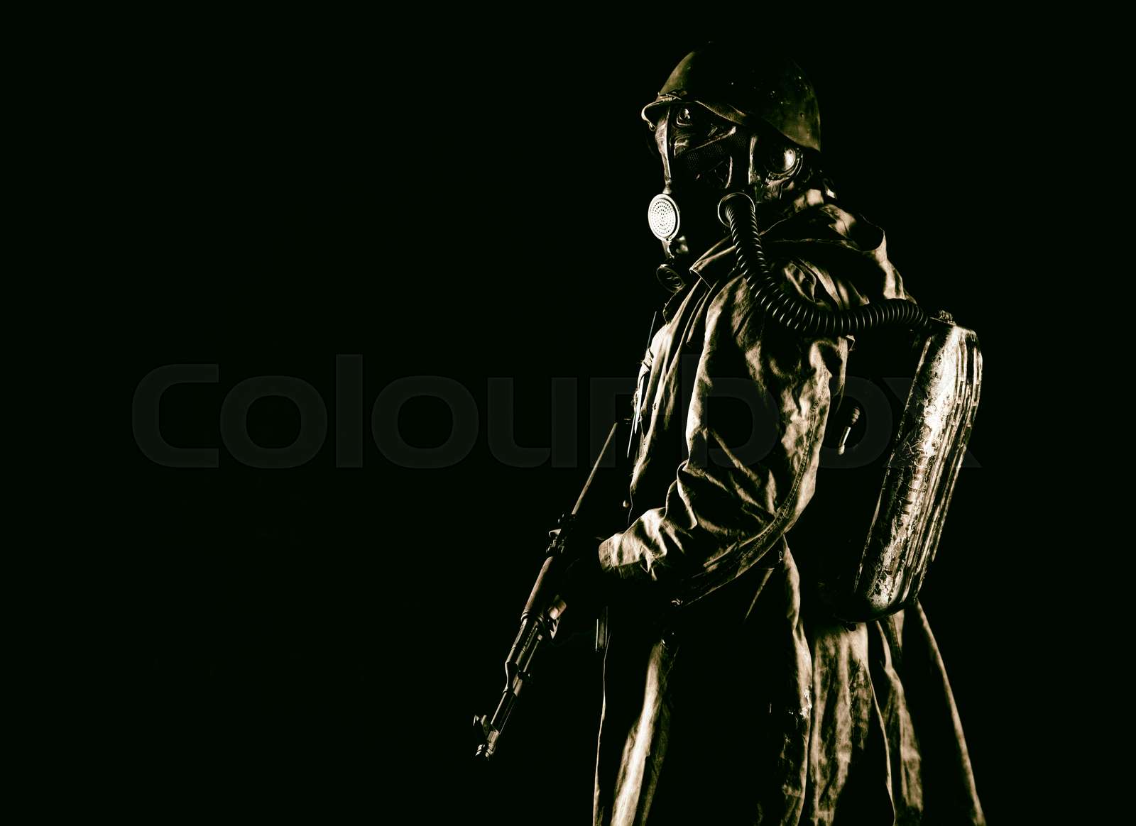 Post apocalyptic soldier aiming firearm weapon | Stock image | Colourbox