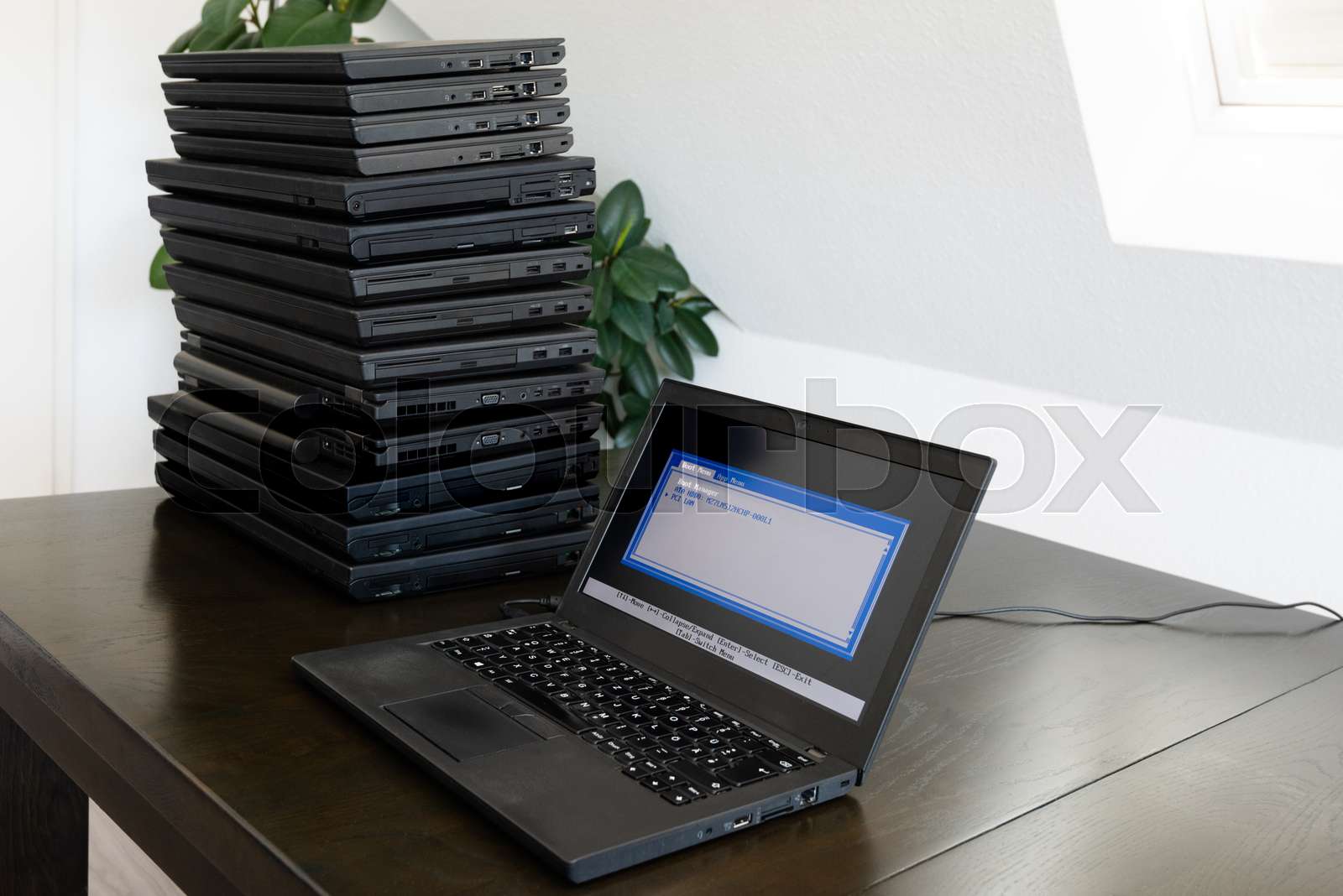 Installation of a laptop computer with a stack of several more ...