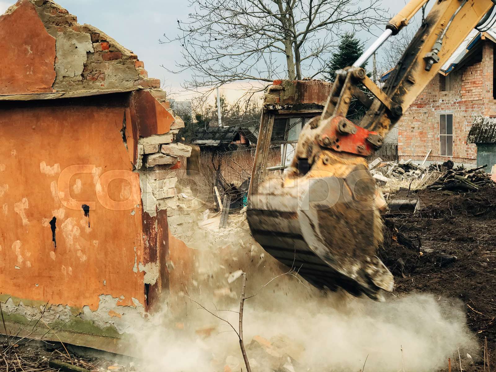 House crushing and collapse. Excavator destroying brick house on land ...