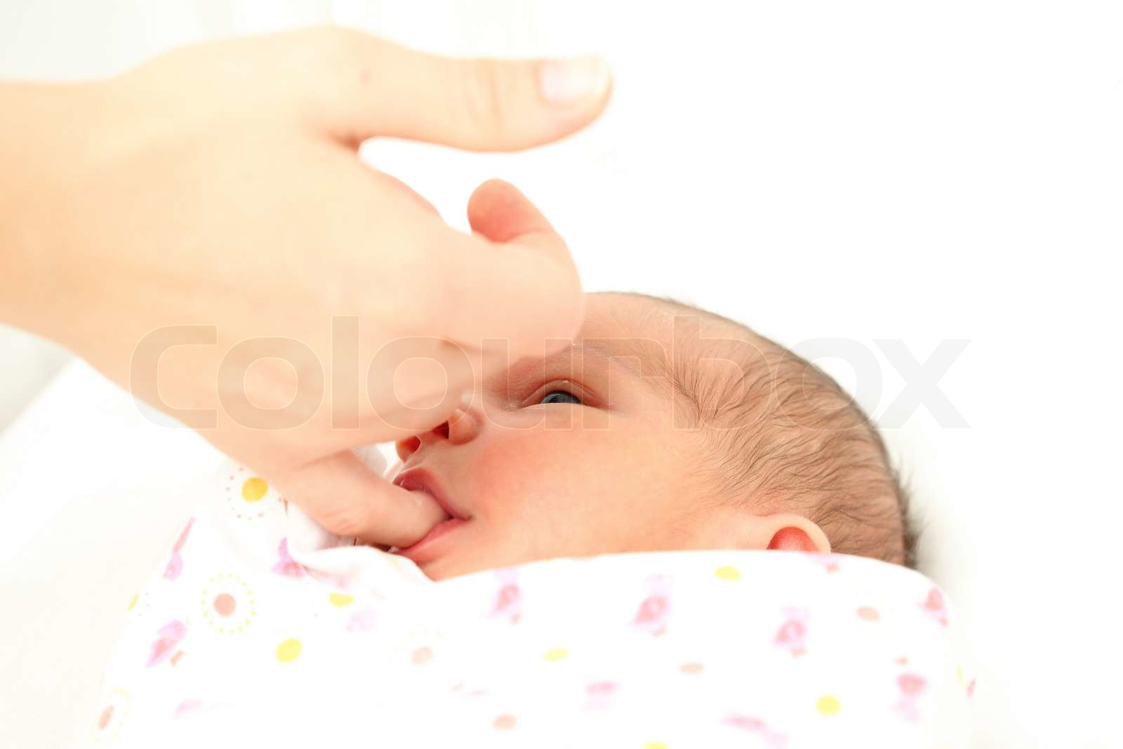 Newborn baby sucking on mothers finger Stock image Colourbox