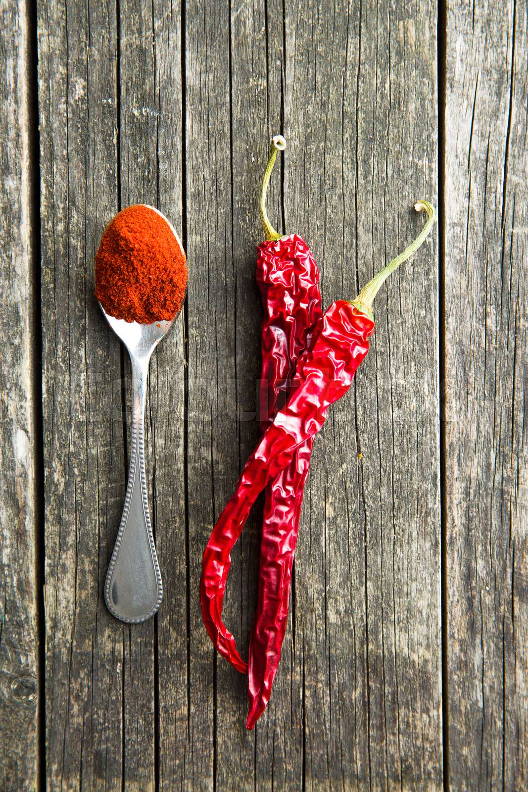 Chili peppers and powdered pepper. Stock image Colourbox