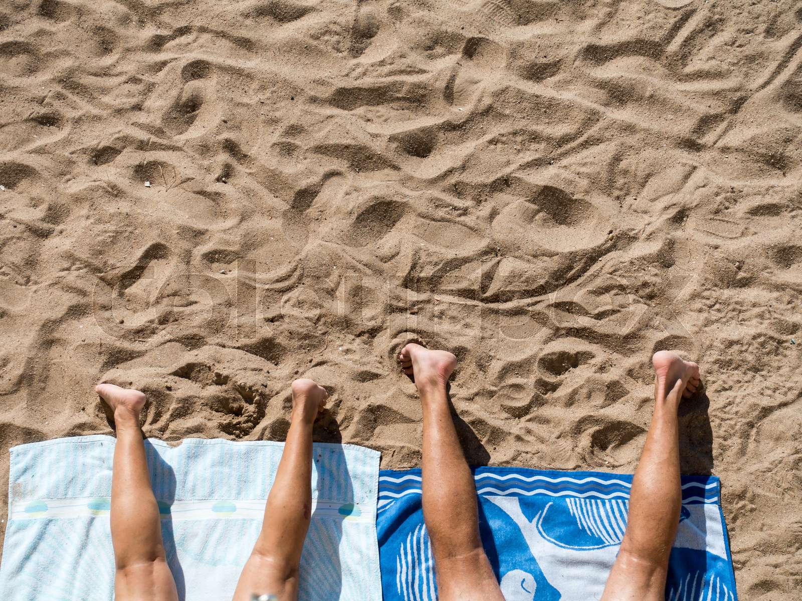 couple sunbathing on the beach | Stock image | Colourbox