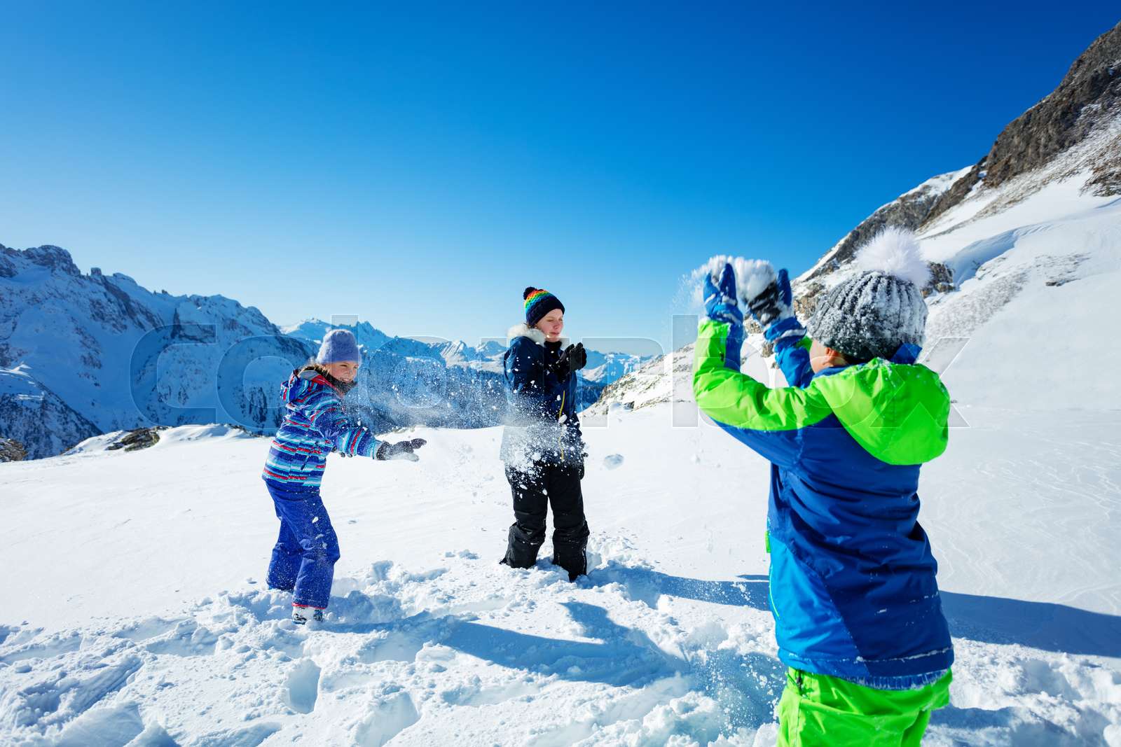 Fun snowball fight in the mountain with friends | Stock image | Colourbox