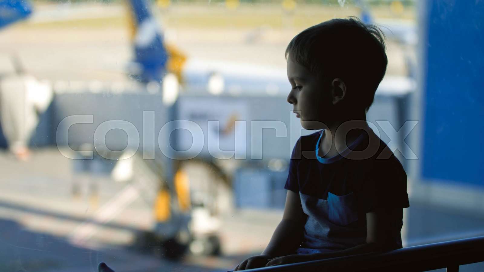 Portrait Of Sad Little Boy Sitting At Big Window In Airport Terminal Portrait Of Sad Little Boy Sitting At Big Window In Airport Terminal