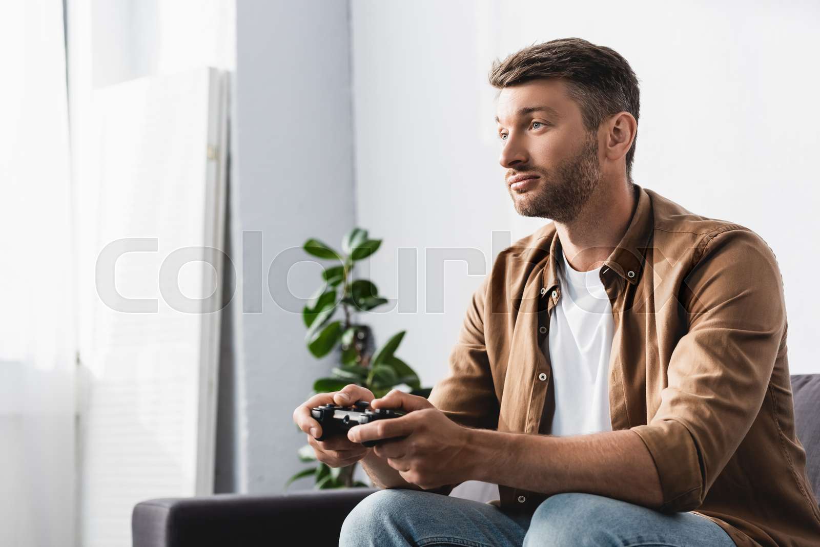 KYIV UKRAINE JUNE 9 2020 Thoughtful Man Sitting On Sofa And kyiv-ukraine-june-9-2020-thoughtful-man-sitting-on-sofa-and