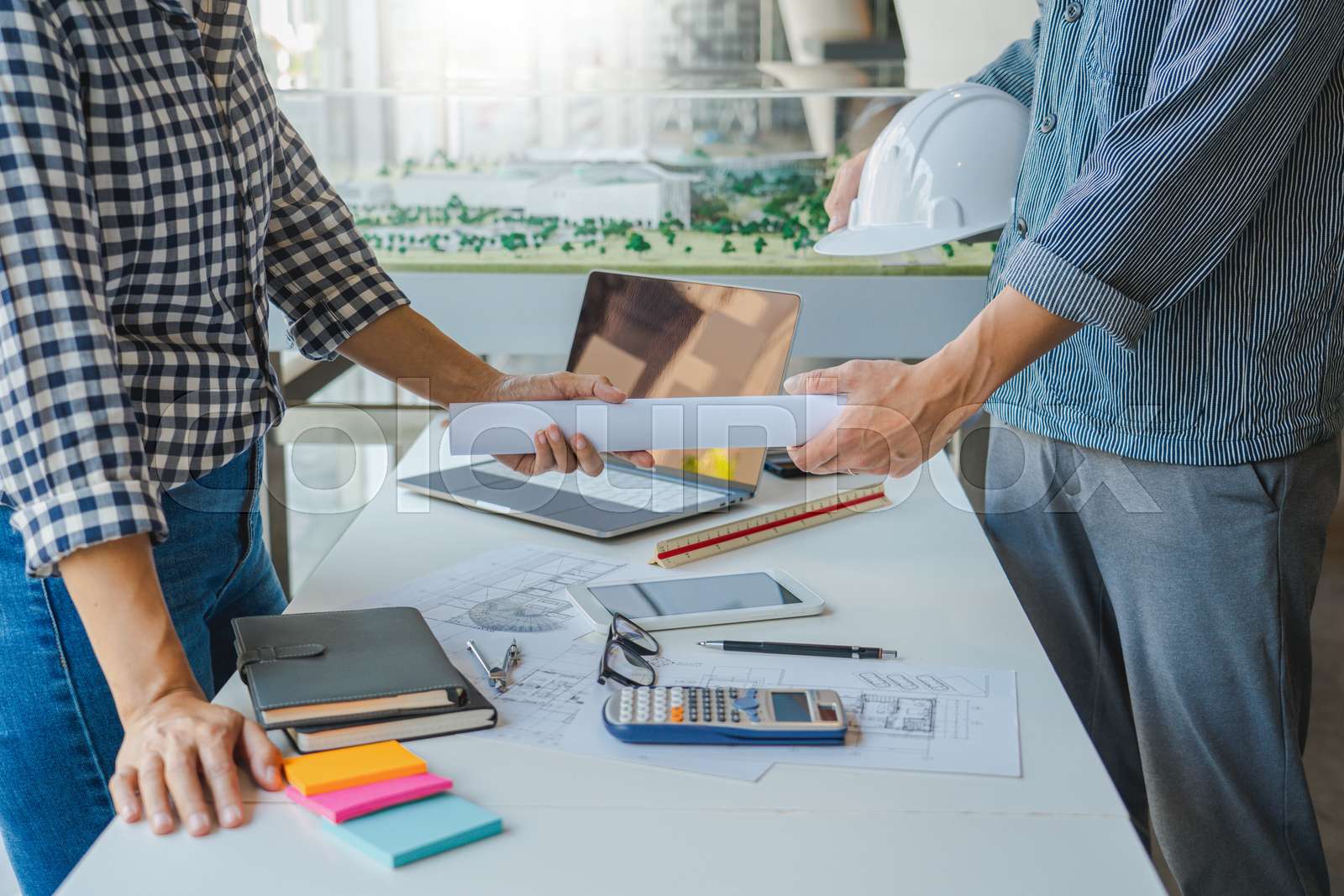 engineer Hand Drawing Plan On Blue Print with architect equipment discussing the floor plans over blueprint architectural plans at table in a modern office.