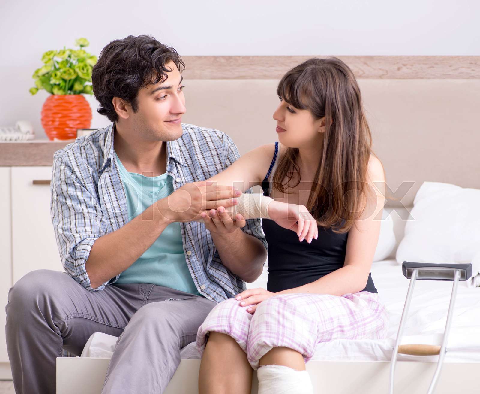 Caring husband looking after his injured wife Stock image Colourbox