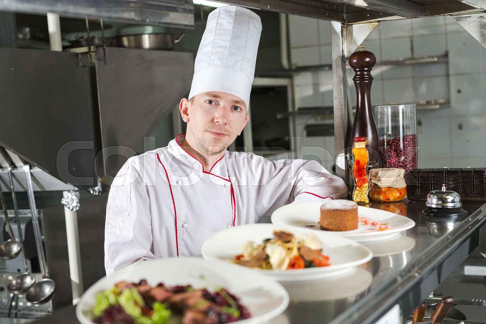 Portrait of a chef with cooked food in the Kitchen in the restaurant
