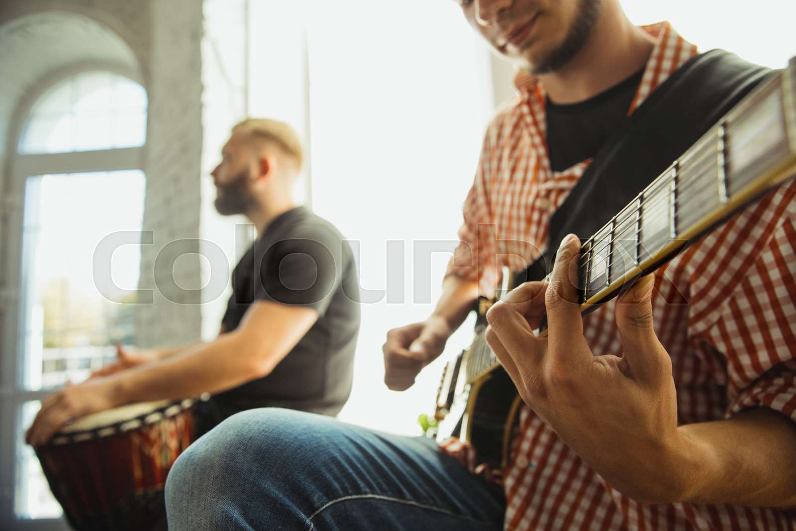 Musician band jamming together in art workplace with instruments ...