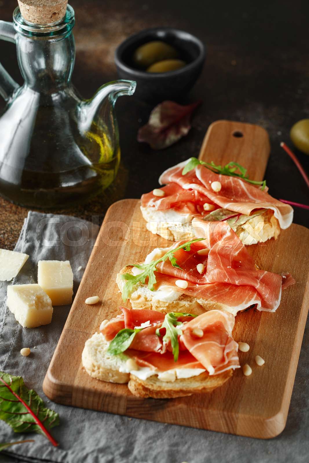 Traditional parma cured ham antipasto. Bruschetta set with Parma Ham