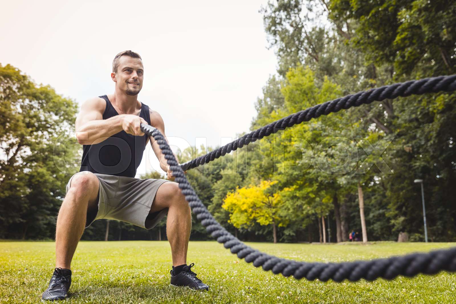 Man using battle rope during workout | Stock image | Colourbox