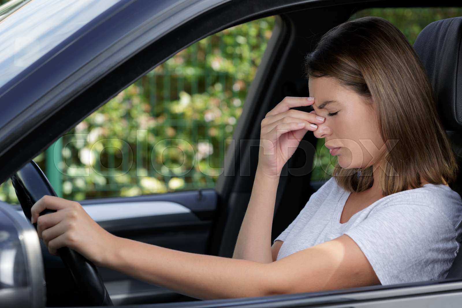 female driver with headache in a car Stock image Colourbox