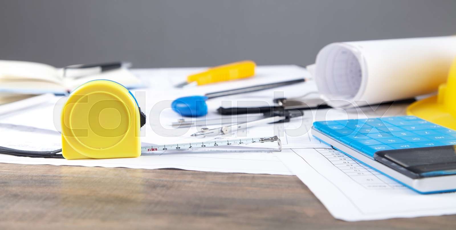 Architects workplace with measure tape, architectural project plan and