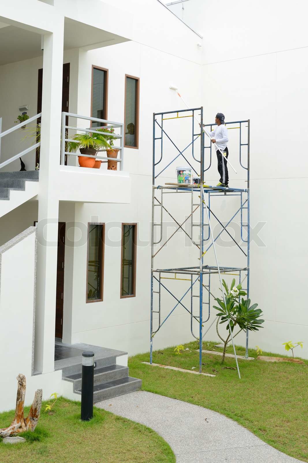 The painter is on the scaffolding | Stock image | Colourbox