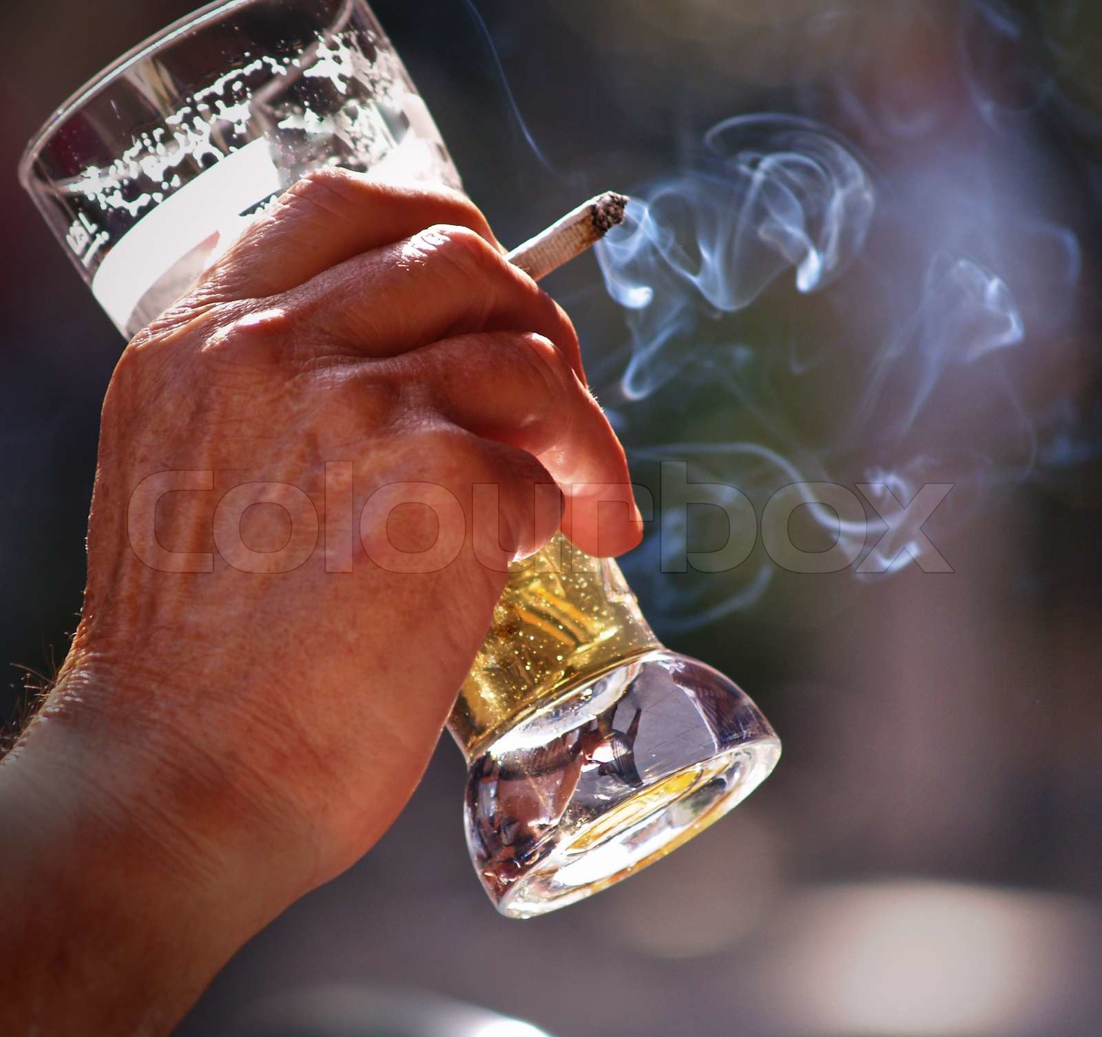Drinking beer and smoking cigarettes stock image colourbox
