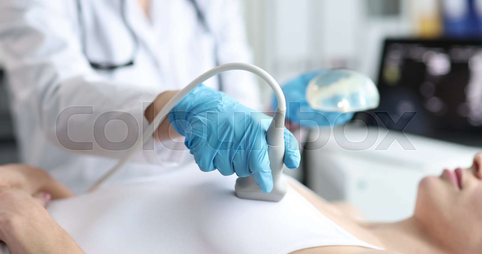 Doctor ultrasound probe breast silicone implant performs medical