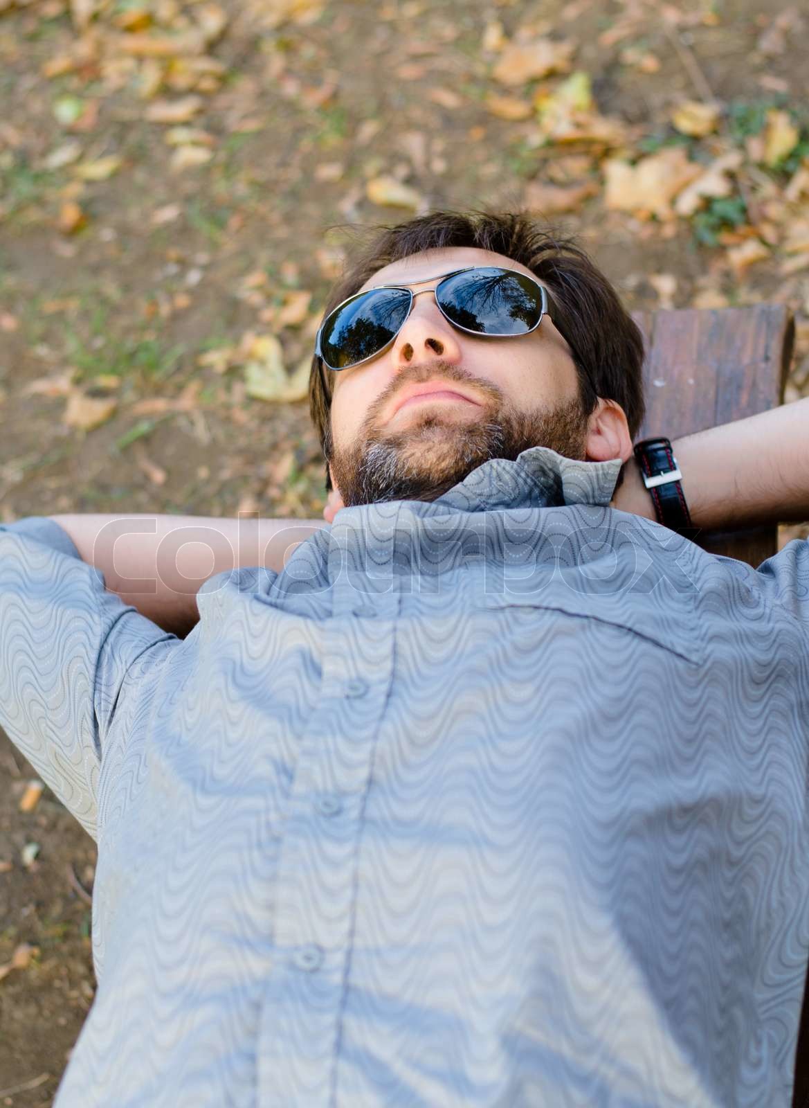 Man ruht auf einer Holzbank | Stock Bild | Colourbox