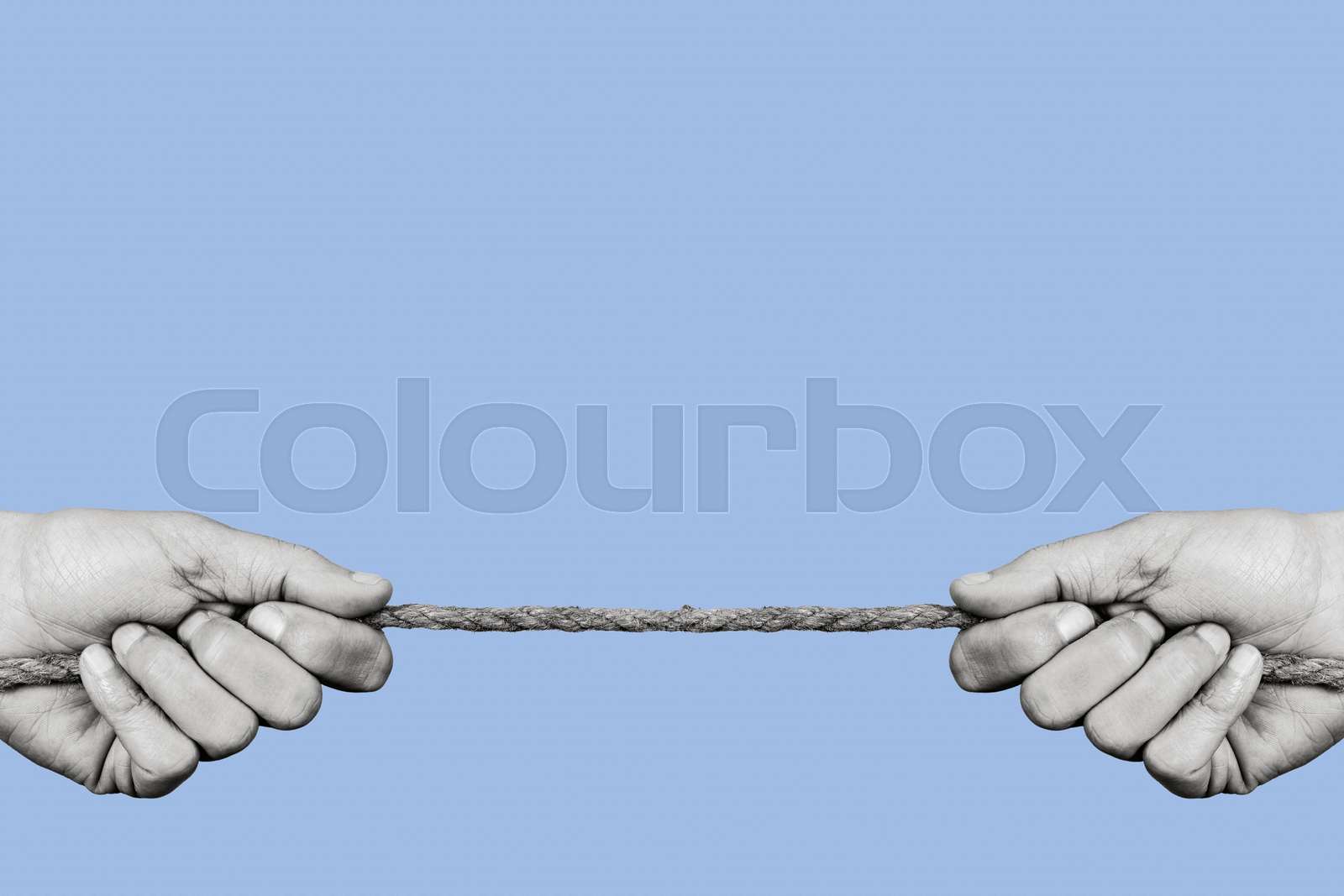 man pulling both ends of a rope | Stock image | Colourbox